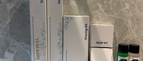 Three boxes labeled 'Dental Kit' and 'Shaving Kit', and two bottles of soap labeled 'Imperial Suites'.