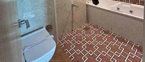 A bathroom with a shower, a toilet, and a bathtub.