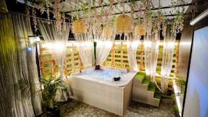 A spa area with a hot tub, wooden flooring, and decorative curtains. - The Nines Hotel & Restro (Haldwani)