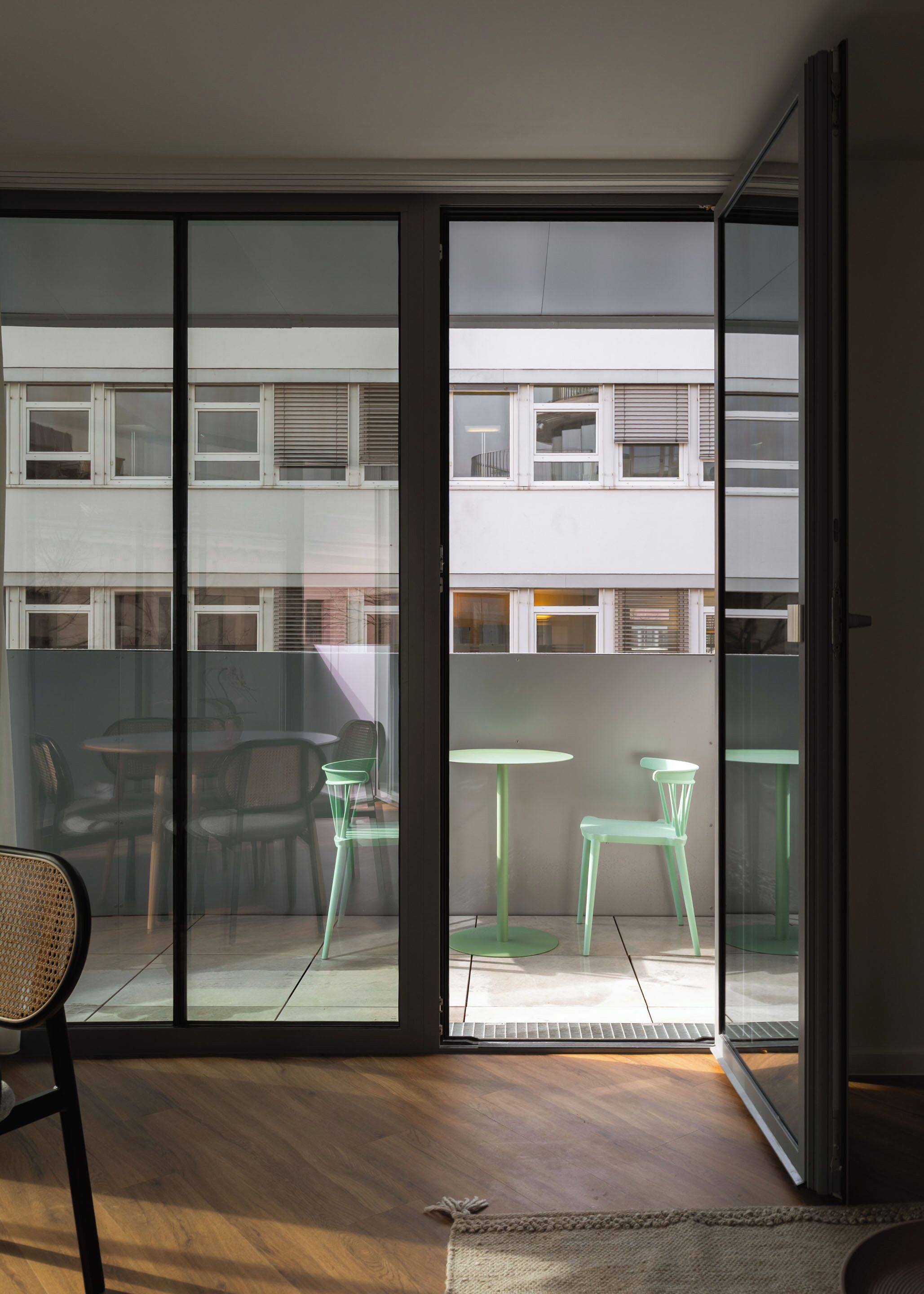 A modern room with a large sliding glass door leading to an outdoor patio area.