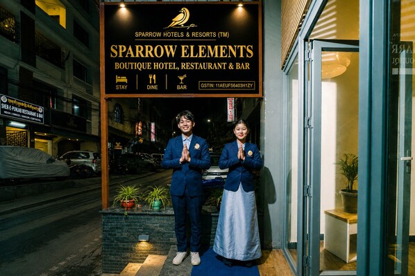 A hotel entrance with a sign for Sparrow Elements Boutique Hotel, Restaurant & Bar.