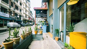 A hotel entrance with potted plants, a reception desk, and a sign for 'SPARROW HOTEL & RESTAURANT'. - Sparrow Elements Boutique Near MG Marg (Gangtok)