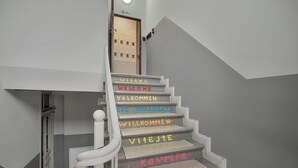 A staircase with steps labeled in multiple languages welcoming visitors. - Climatic Studio in the Center | Close to Public Transport (Bydgoszcz)
