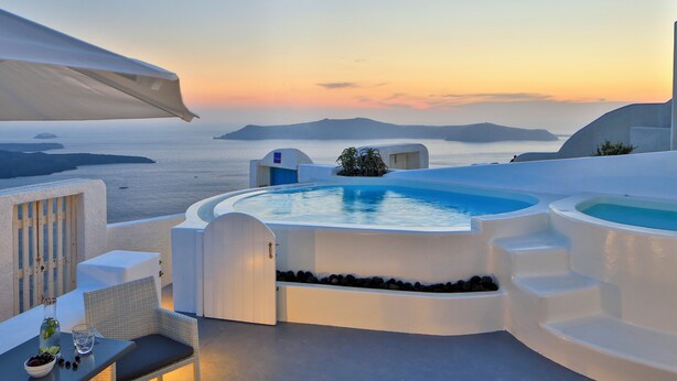A rooftop infinity pool with a view of the sea and islands at sunset. - Cloud 9 (Santorini)