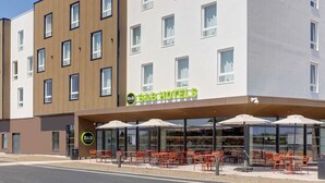 A B&B hotel with outdoor seating and a modern facade.