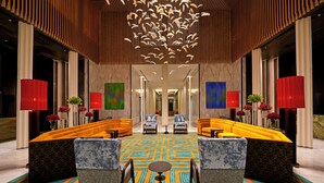 A lobby with a central seating area, a patterned carpet, and a modern ceiling design. - The Residency Signature Madurai (Madurai)