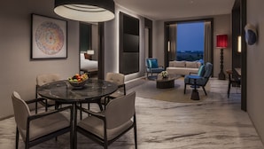A modern interior with a dining area, seating, and a large window. - The Residency Signature Madurai (Madurai)