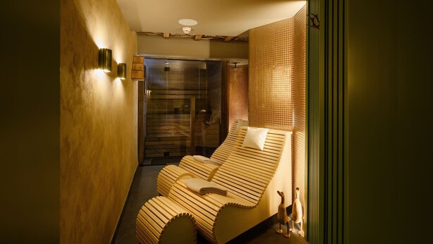 A modern, compact room with a wooden bed, a glass shower, and a green accent wall. - Franz Apartments  (Ilirska Bistrica)