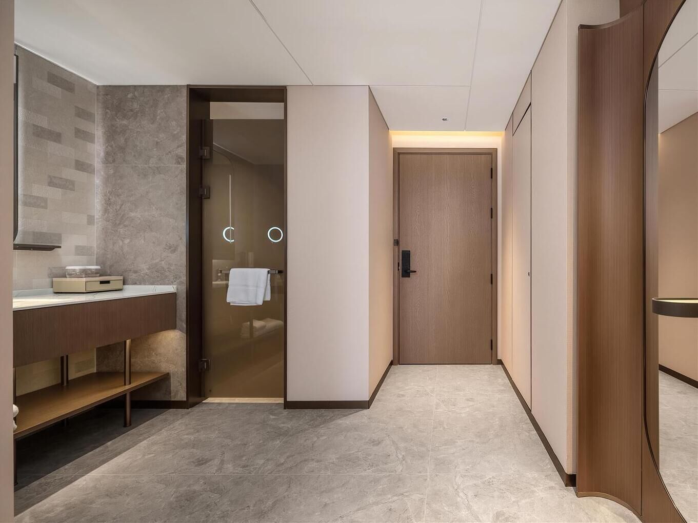 A modern bathroom with a vanity, a towel rack, and a shower area.