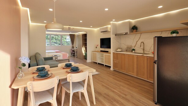 A modern kitchen with wooden cabinets, a black refrigerator, and a dining area with a table and chairs. - Alesea Suites: Surf Town Deluxe Suite 1 (San Fernando City)