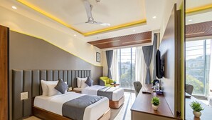 A modern hotel room with two beds, a desk, a chair, a TV, and a large window. - S by Z Hotels, Baani Square (Gurugram)