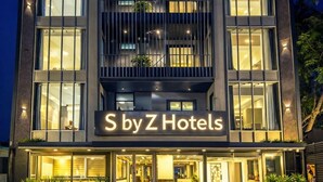 A modern hotel building with the sign "S by Z Hotels" illuminated. - S by Z Hotels, Baani Square (Gurugram)