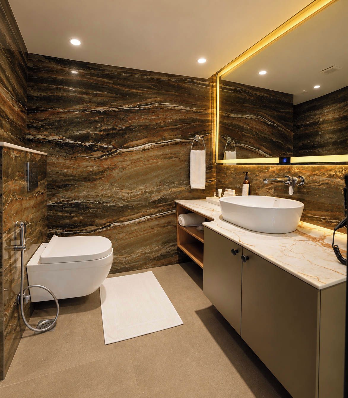 A modern bathroom with a marble vanity, a toilet, and a large mirror.