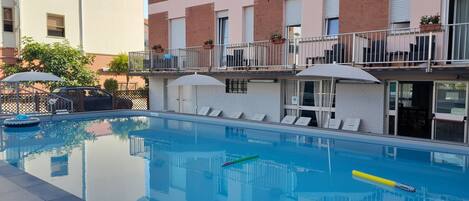 Seasonal outdoor pool, open 9:00 AM to 9:00 PM, pool umbrellas