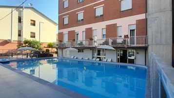 Seasonal outdoor pool, open 9:00 AM to 9:00 PM, pool umbrellas