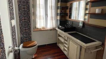 Une petite salle de bain comprenant des toilettes, un bidet et un lavabo.