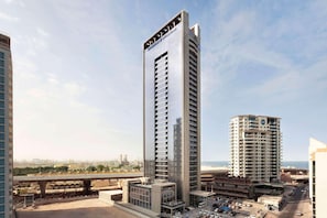A high-rise hotel with a modern design, featuring multiple floors and a prominent entrance. - The First Collection Marina (Dubai)