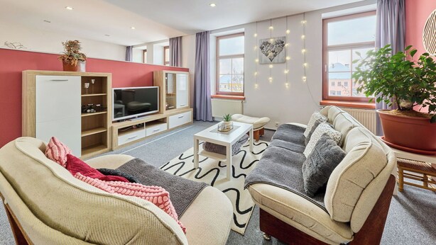 A modern living room with a TV, sofa, and a large window. - Beautiful apartment for 4 guests with WIFI and TV (Turnov)