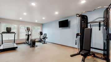 A gym with treadmills, an elliptical, and a weight machine.