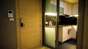 A modern kitchen with a built-in stove, a coffee maker, and a microwave.