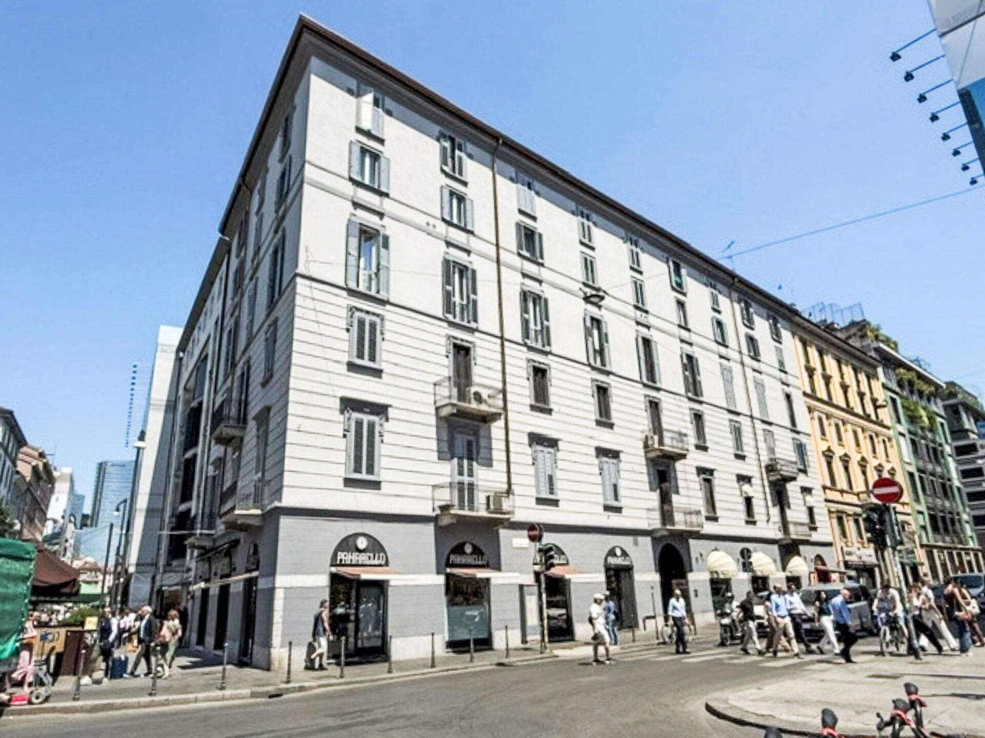 A multi-story building with a classic architectural style, featuring a ground-floor entrance with signage.
