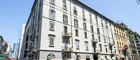 A multi-story building with a classic architectural style, featuring a ground-floor entrance with signage.