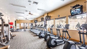 A gym with treadmills, stationary bikes, and weight machines.