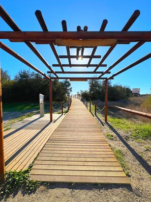 A wooden pathway leading to a pergola structure. - Divina Pastora by Residea (El Morche)
