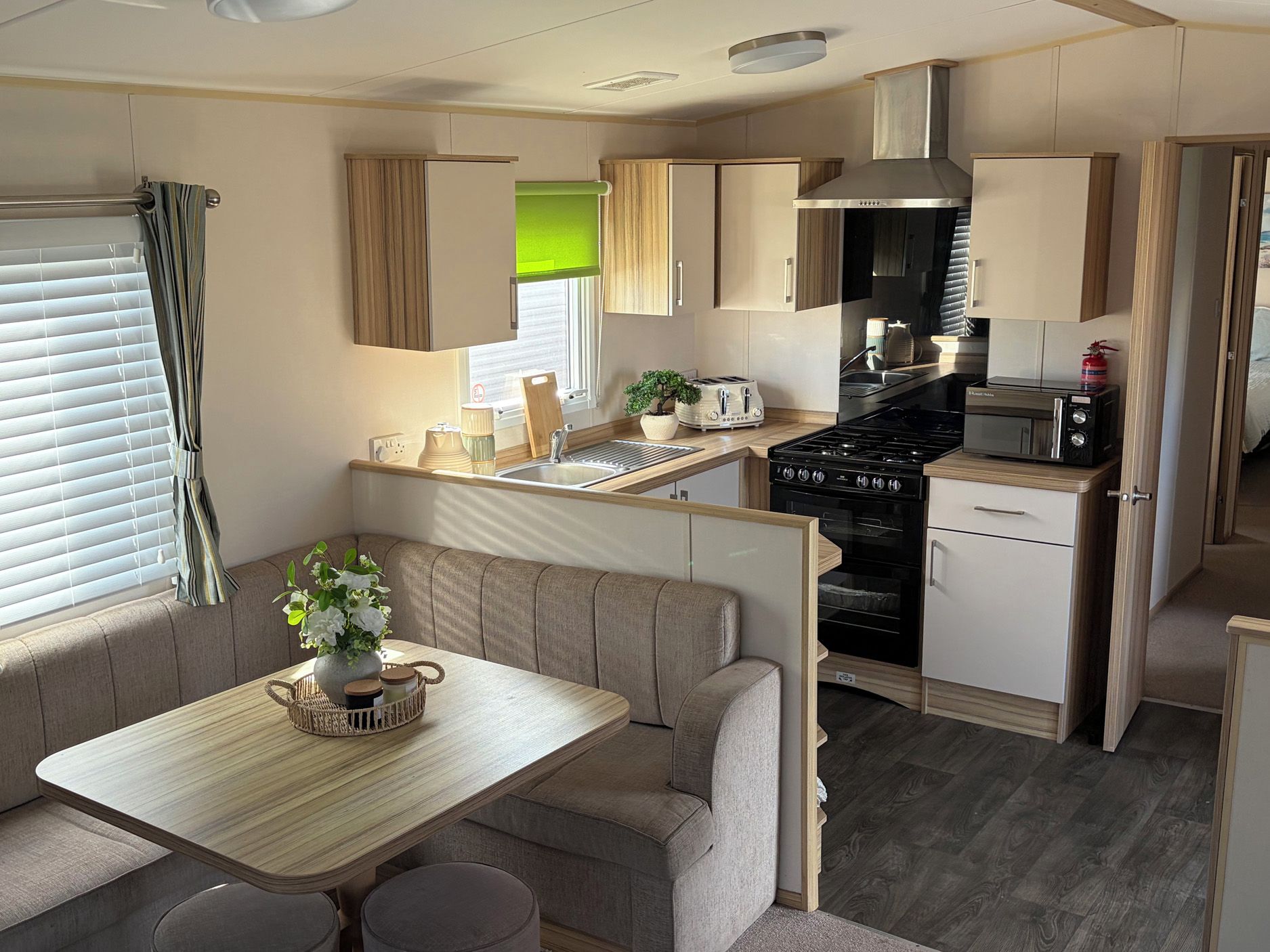 A compact kitchenette with a stove, microwave, and toaster.
