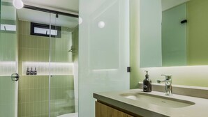 A modern bathroom with a glass shower enclosure, a toilet, and a vanity with a mirror and sink. - NOK Spacious 3BR Apartment Near Zona T Bogota (Bogotá)