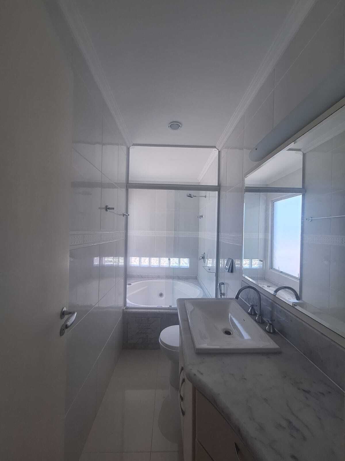 A modern bathroom with a glass-enclosed shower, a standalone bathtub, and a marble vanity with a sink.