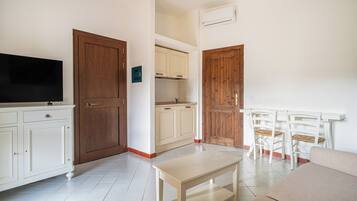 Comfort Apartment | Living area | 35-inch TV with satellite channels