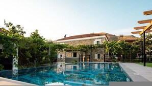 A swimming pool with a stone building in the background. - Filippos Traditional Villa - Pool Garden Gem (Finiq)