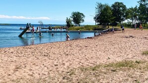 A beach with a swimming pool, a slide, and people enjoying the water. - 4 Star Holiday Home in Bergkvara (Bergkvara)