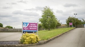 Bordje voor een hotelparkeerplaats met routebeschrijving voor hotelgasten.