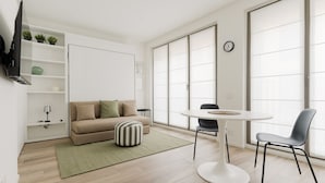 A modern living room with a sofa, ottoman, round table, and chairs. - GuestHost - Modern 40 mq studio apartment located on the first floor of a residential complex with a lift.The property is located within the Moscova district, a well-known central area of ​​Milan, the hub of Milanese nightlife and aperitifs.The area  (Milan)