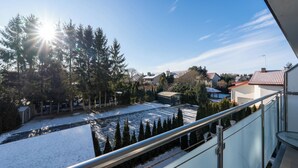 A residential area with snow-covered ground, houses, and trees. - Apartamenty Sun & Snow Welle Resort (Grzybowo)