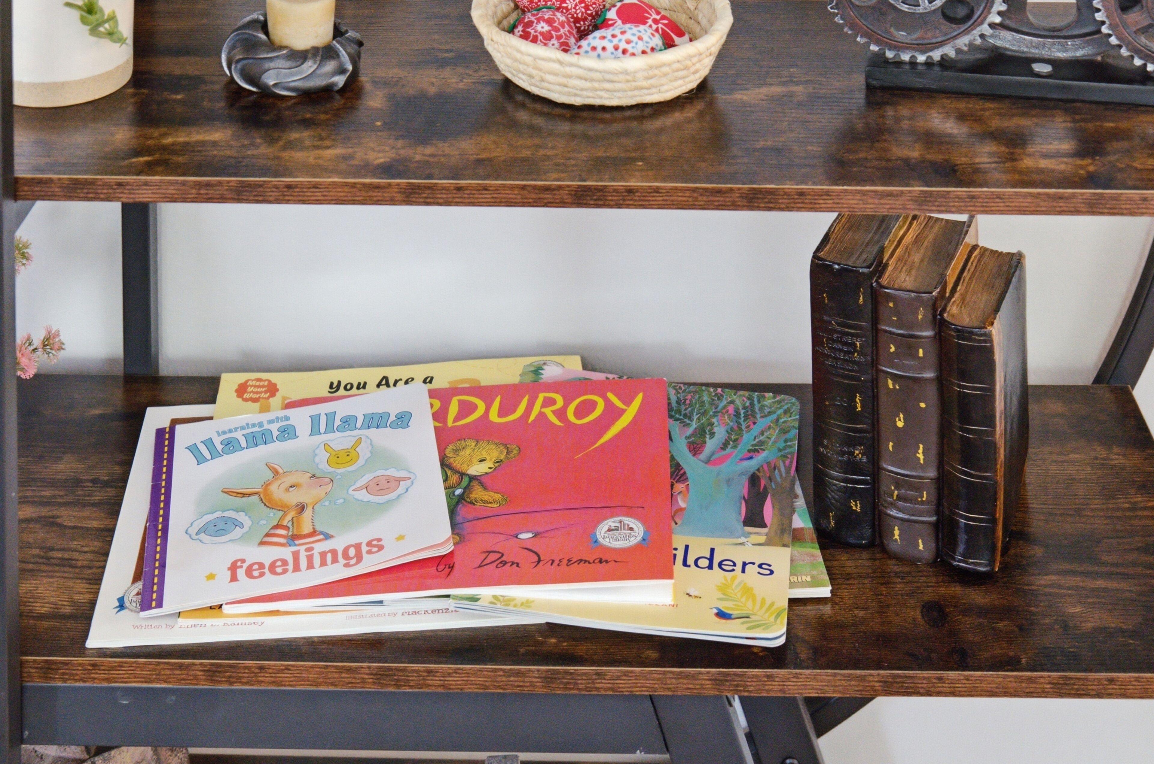 A wooden shelf with books and decorative items.