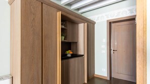 A wooden wardrobe with a black countertop and a potted plant. - 105 Iris Deluxe Room (Palermo)