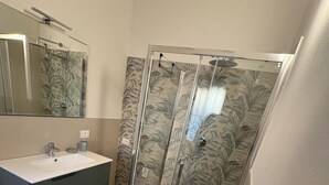 A bathroom with a shower, sink, and mirror. - Sweet & home 3 Apartment Delux near Bergamo (Azzano San Paolo)