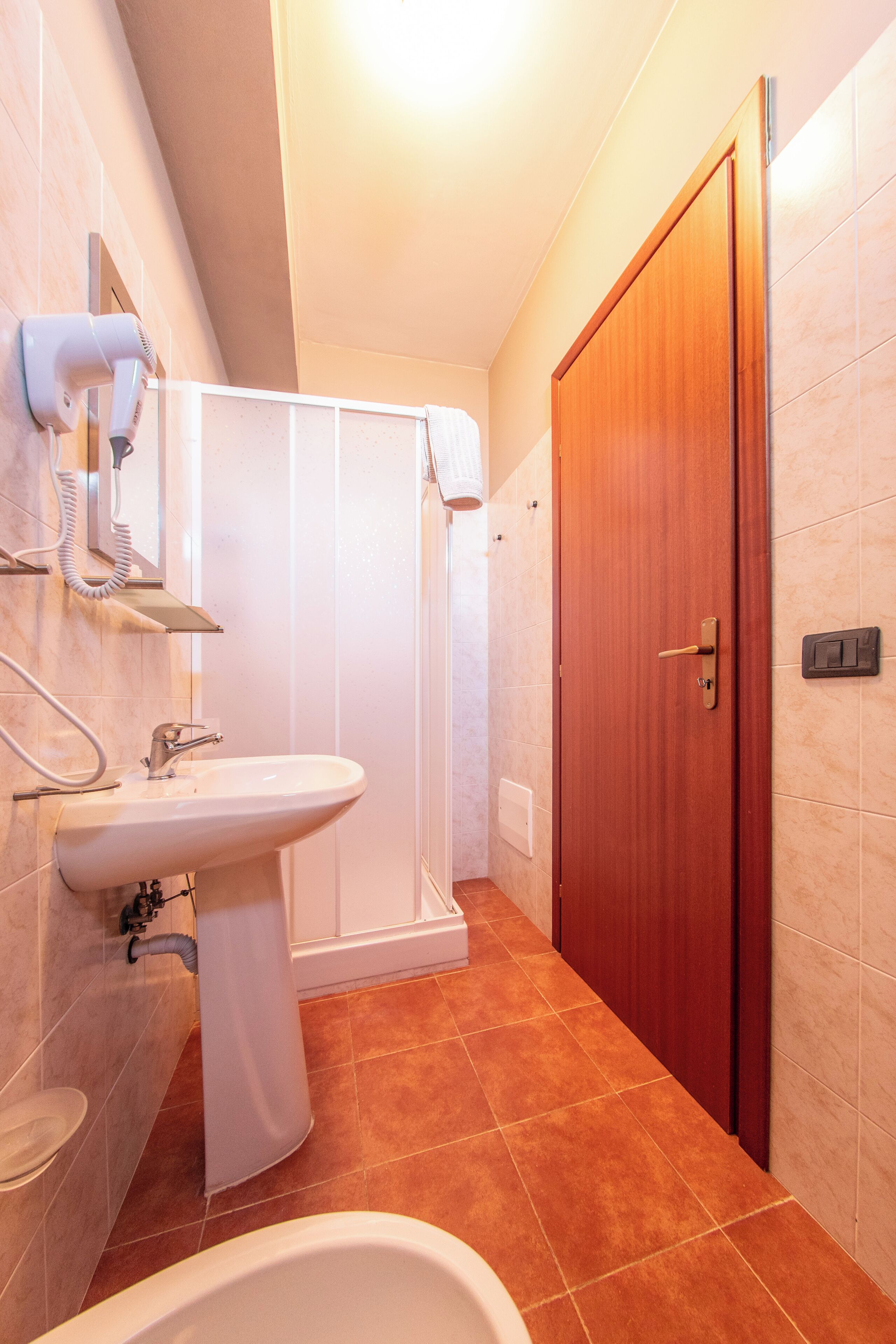 A bathroom with a sink, a shower, and a toilet.
