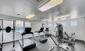 A gym with treadmills, weight machines, and a bench. - Luxury Seven Hills Escape - 1BR, Pool & Garage (Henderson)