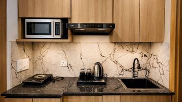 Mini-fridge, microwave, dishwasher, cookware/dishes/utensils