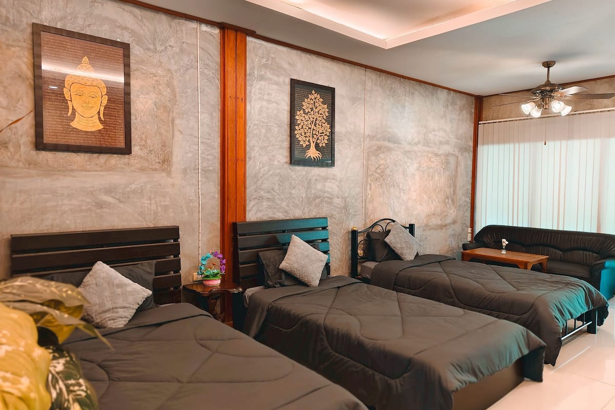 Une chambre d’hôtel avec deux lits, un mur décoratif en bois et des œuvres d’art accrochées aux murs.