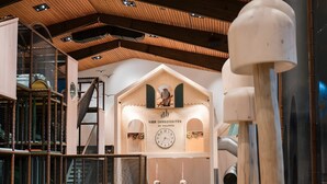 A spacious interior with a wooden ceiling, a clock, and a staircase. - "Fewo Fox'n" – The Clever Accommodation with Pool (Schluchsee)