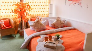 A bedroom with a bed, pillows, a small table with a tray, a chair, and a window with curtains. - "Fewo Fox'n" – The Clever Accommodation with Pool (Schluchsee)