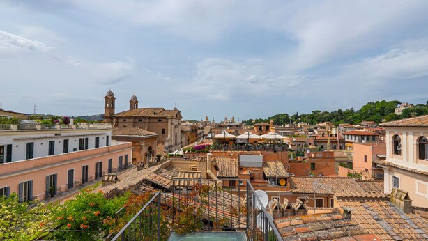 A historic town with traditional architecture, including a prominent church with bell towers, and a view of the surrounding buildings and streets. - Charme and View in the Heart of Rome (Rome)