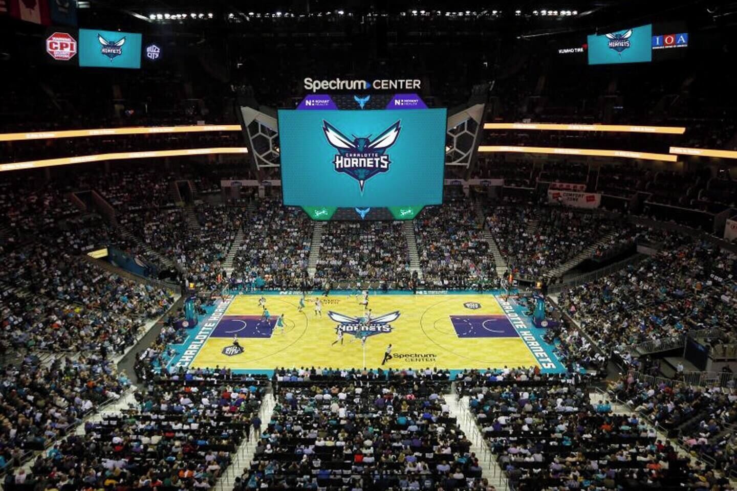 A basketball court with a large crowd in a stadium.