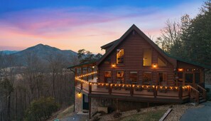 A log cabin with a balcony, deck, and multiple windows. - Best View In The Smokies! Hot Tub, Firepit, Games! (Pigeon Forge)