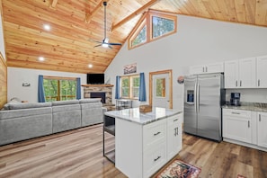 A modern kitchen with white cabinets, a stainless steel refrigerator, and a built-in water dispenser. - Embers Place - Murphy (Murphy)